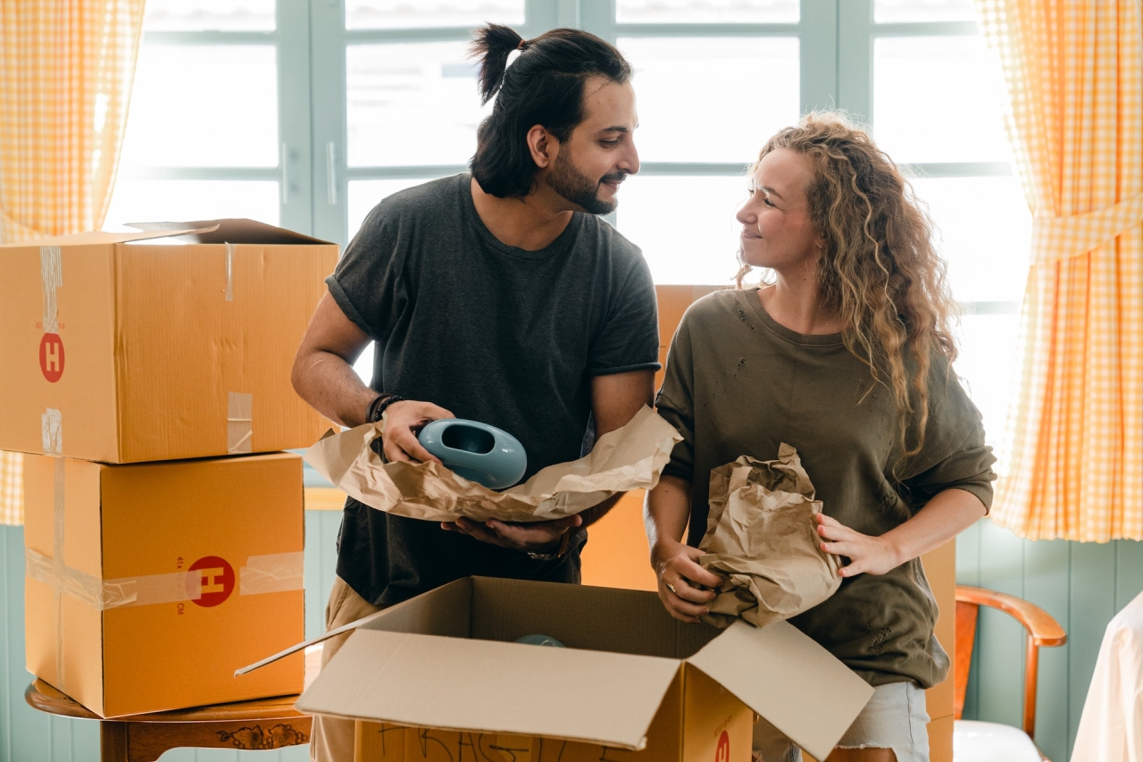 Couple Packing Boxes for Move.